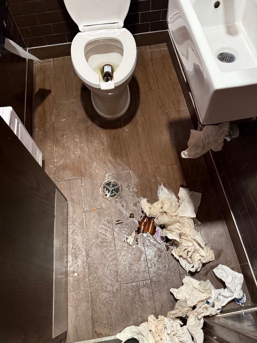 Commercial washroom with debris and broken glass before Trydentt cleaning service